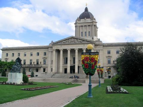  A neoclassical, Beaux-Arts-style building with columns in front. In front of it is a green lawn.