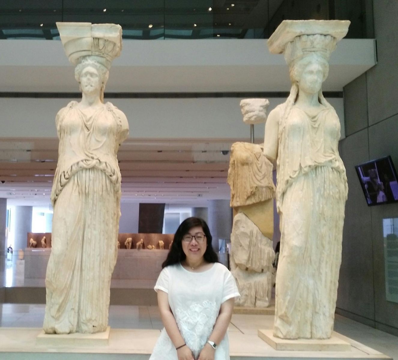 A person standing in front of a statueDescription automatically generated