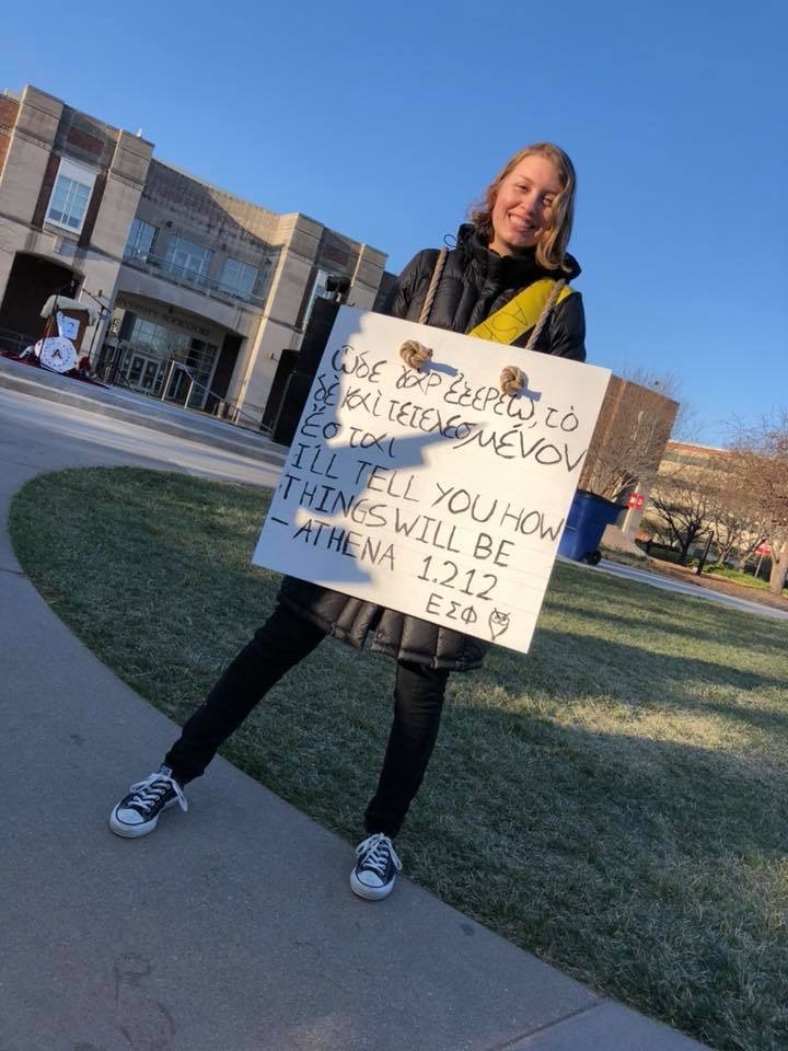 UNL Classics major Paige McCoy drums up support. Photo by Ellie Churchill and used by permission.