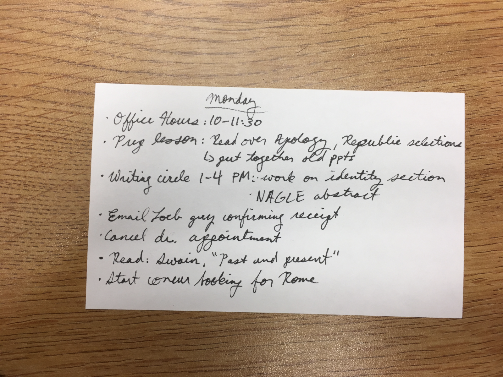 Lindsey’s Monday to-do list, written out by hand on an index card. She got everything but the travel booking done that day.